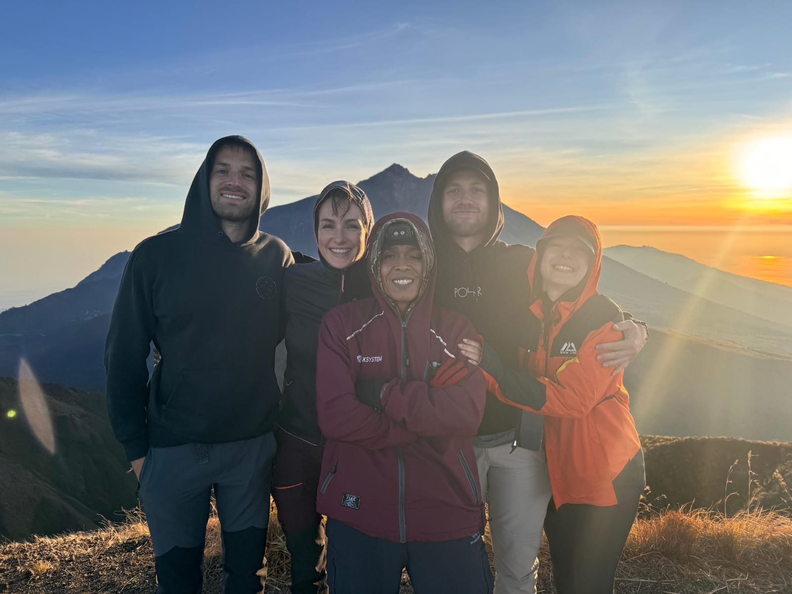 Group photo with local guide as the sun rises over Lombok