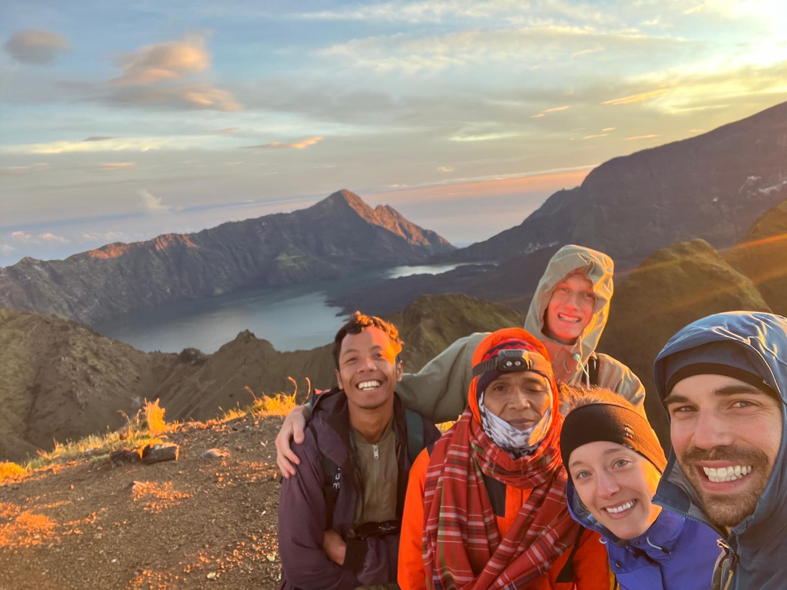 Group selfie with local guide above the crater lake at sunrise