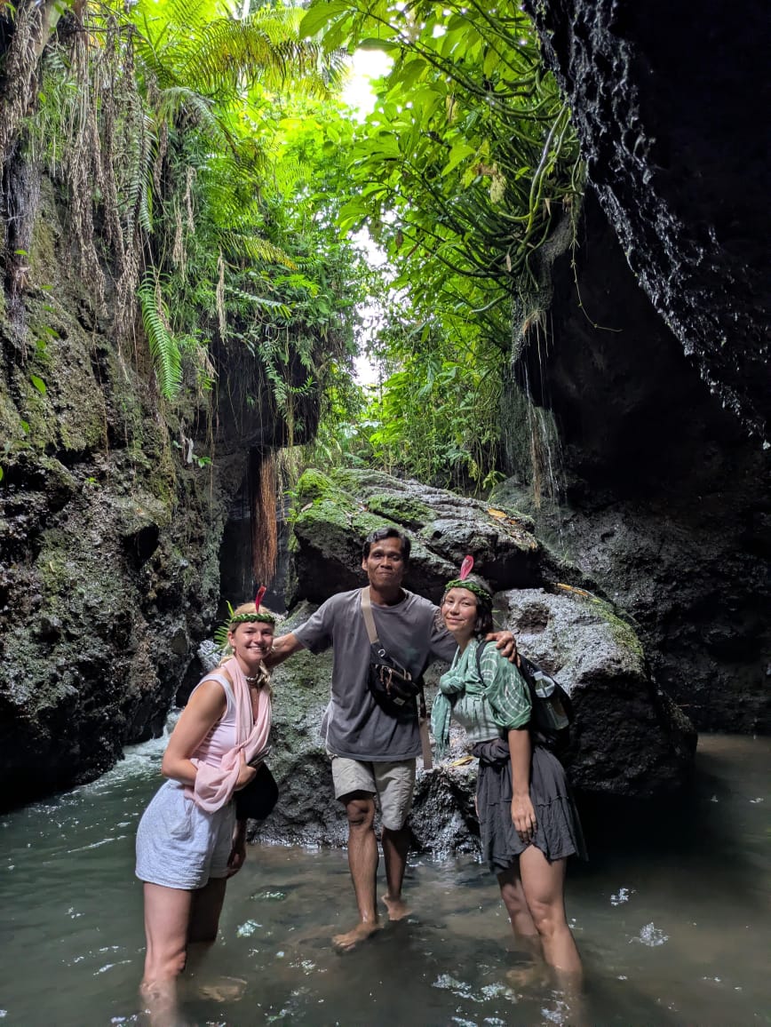 Guests exploring a jungle waterfall canyon with a local guide