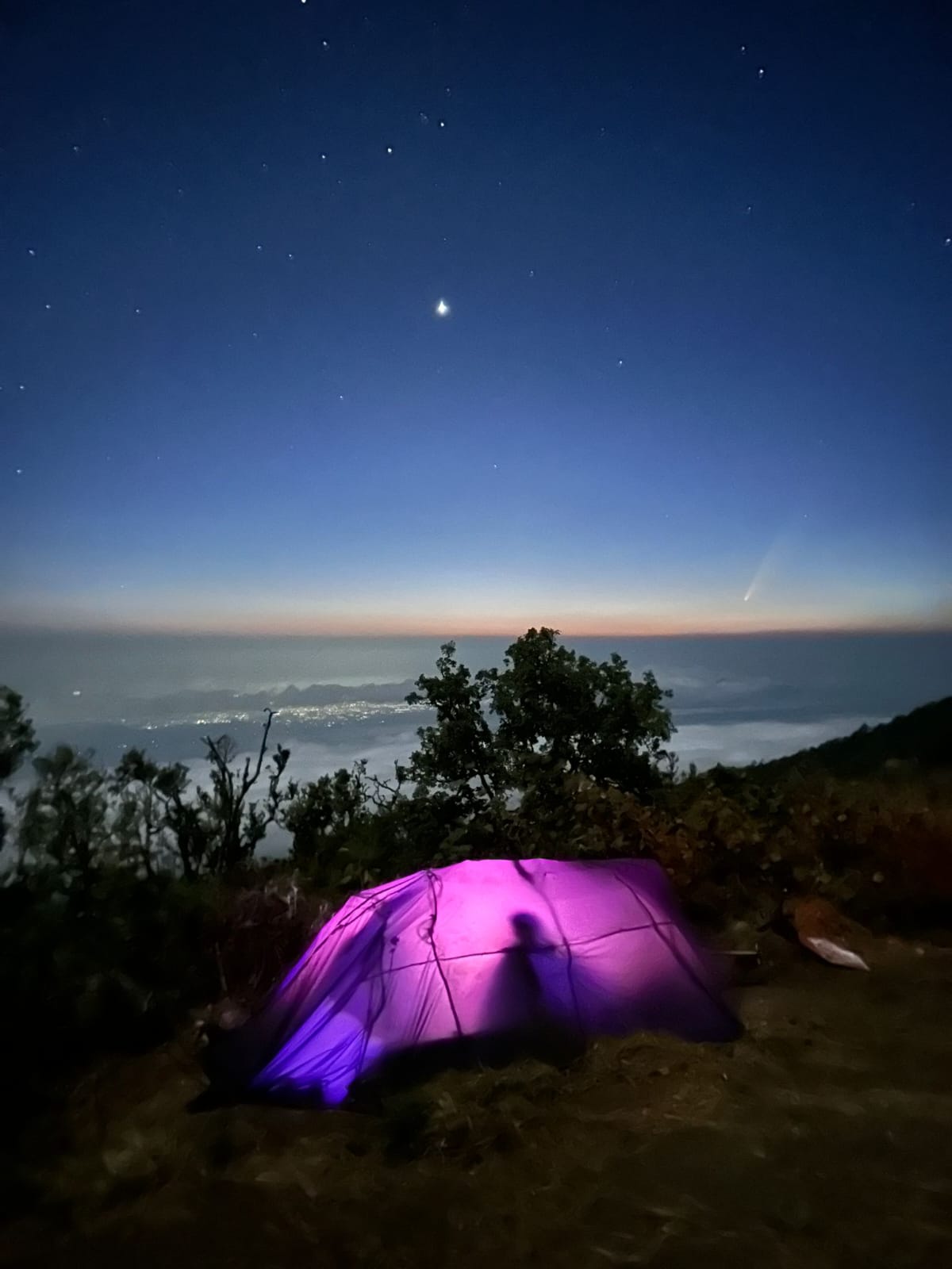 Tent glowing under the stars at high camp on Rinjani